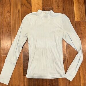 FP Movement Laura Long Sleeve Rib Top in a light blue or mint-toned color.